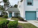Charming home featuring a teal door, teal trim and a well-kept lawn at 6546 Fairway Gardens Dr # 6546, Bradenton, FL 34203