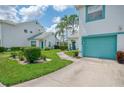 Charming townhome with lush landscaping, teal accents and a quaint walkway at 6546 Fairway Gardens Dr # 6546, Bradenton, FL 34203