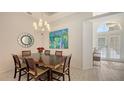 Elegant dining room with chandelier, art, and a view of the foyer, perfect for Gathering gatherings at 6721 Oak Manor Dr, Lakewood Ranch, FL 34202