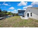 Spacious backyard with a patio area, perfect for outdoor entertaining and enjoying waterfront views at 7308 Maryland Ave, Hudson, FL 34667