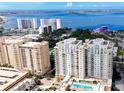 A stunning aerial view overlooking waterfront condos, a marina, and the sparkling bay at 800 N Tamiami Trl # 317, Sarasota, FL 34236