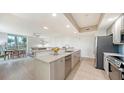 Open-concept kitchen with granite countertops, stainless steel appliances, and seamless flow to the living area at 800 N Tamiami Trl # 317, Sarasota, FL 34236