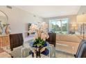 Stylish dining area with a glass table and views of the beautifully manicured backyard at 8735 Olde Hickory Ave # 8205, Sarasota, FL 34238