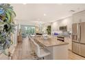 Bright, open kitchen with granite counters, stainless steel appliances, and a view into the living room at 8735 Olde Hickory Ave # 8205, Sarasota, FL 34238