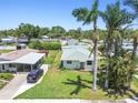 Aerial view of home showcasing the landscaped yard, fenced perimeter, and proximity to neighboring houses at 1200 25Th W Ave, Palmetto, FL 34221