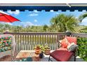 A charming deck with potted plants and comfortable lounge seating overlooking the water at 1312 Perico Point Cir, Bradenton, FL 34209