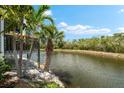 View of waterfront with vegetation and elevated deck, highlighting a serene outdoor space at 1312 Perico Point Cir, Bradenton, FL 34209