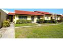 Inviting one-story home featuring a vibrant red tile roof and manicured lawn at 1314 57Th W St # 1314, Bradenton, FL 34209