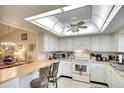 Bright kitchen featuring white cabinets, and modern appliances at 1314 57Th W St # 1314, Bradenton, FL 34209