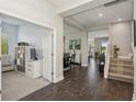 Inviting hallway with gleaming dark wood floors leading to various living spaces, promoting an open and airy feel at 13708 Old Creek Ct, Parrish, FL 34219