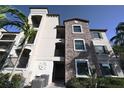 Mediterranean-style condo with stone accents, balconies, and well-maintained landscaping at 16904 Vardon Ter # 208, Lakewood Ranch, FL 34211