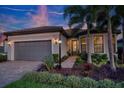 Charming single-story home with a two-car garage, lush landscaping, and beautiful paver driveway at 18008 Waterville Pl, Bradenton, FL 34202