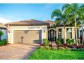 Charming single-story home with a two-car garage, lush landscaping, and beautiful paver driveway at 18008 Waterville Pl, Bradenton, FL 34202