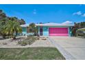 Attractive single-story home with a unique, vibrant exterior paint scheme and well-kept landscaping at 2127 Corfell St, Port Charlotte, FL 33948