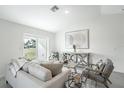 Bright living room with sliding glass doors leading to the backyard and stylish contemporary decor at 22318 Alcorn Ave, Port Charlotte, FL 33952
