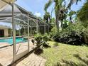 Enjoy the screened-in pool area surrounded by lush landscaping, providing a private backyard oasis at 2809 112Th E Ter, Parrish, FL 34219