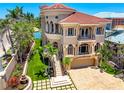 Expansive waterfront property with meticulously manicured landscaping, charming water fountain, and paver driveway at 290 N Washington Dr, Sarasota, FL 34236
