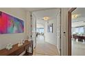 Inviting foyer with an elegant console table, art, and entry to the living spaces with ocean views at 3060 Grand Bay Blvd # 182, Longboat Key, FL 34228
