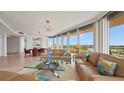Bright living room with comfortable seating, floor-to-ceiling windows, and views of the golf course at 3060 Grand Bay Blvd # 182, Longboat Key, FL 34228
