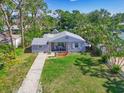 Charming single-story home with inviting front porch and well-kept lawn and landscape at 3212 Avenue A W, Bradenton, FL 34205
