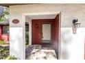 Close-up of the front entrance with a decorative door and stone-paved porch at 3934 Brookside Dr, Sarasota, FL 34231