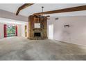 Bright living room featuring beamed ceilings, a stone fireplace, and an open layout at 3934 Brookside Dr, Sarasota, FL 34231