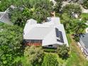 Aerial view showcasing the unique roofline, mature trees and lush landscaping at 4443 Robin Hood W Trl, Sarasota, FL 34232