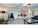 Inviting living room with hard surface flooring, a ceiling fan, and an open floor plan into other rooms at 4873 Huntleigh Dr, Sarasota, FL 34233