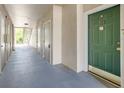 Exterior hallway showing doors and a stairway leading to an outdoor area with natural light at 5168 Northridge Rd # 106, Sarasota, FL 34238