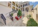 Inviting courtyard with brick pavers, iron railings, and comfortable seating for a relaxing outdoor experience at 525 N Orange Ave # 202, Sarasota, FL 34236