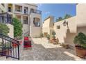 Charming courtyard featuring brick pavers, wrought iron railings, cozy seating, and landscaping, perfect for outdoor relaxation at 525 N Orange Ave # 202, Sarasota, FL 34236