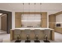 Modern kitchen with a large island, pendant lighting, stainless steel appliances, and lots of cabinet space at 555 Quay Cmn # 1003, Sarasota, FL 34236