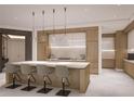Modern kitchen with a large island, pendant lighting, stainless steel appliances, and lots of cabinet space at 555 Quay Cmn # 1003, Sarasota, FL 34236