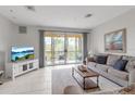 Cozy living room with neutral tones, balcony, and a lovely view of the outdoors at 603 Cedars Ct, Longboat Key, FL 34228