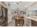 Bright kitchen featuring stainless steel appliances, kitchen island, and an open concept dining area at 6766 Beedla St, North Port, FL 34291