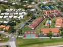 Aerial view of community featuring pool, tennis courts and marina at 709 Sorrento Inlt # 709, Nokomis, FL 34275