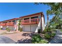 Two-story condominium featuring a 2-car garage and front balcony at 709 Sorrento Inlt # 709, Nokomis, FL 34275