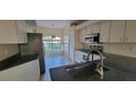 The kitchen features sleek countertops and modern appliances, including a stainless steel refrigerator at 7102 52Nd E Dr, Bradenton, FL 34203