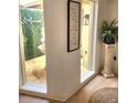 Inviting foyer with a serene courtyard view, elegant decor, and natural light at 7118 Lakeside Dr # 7118, Sarasota, FL 34243