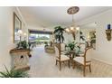 Inviting living area featuring neutral tones, recessed lighting, and a large window overlooking the landscaped backyard at 8422 Wethersfield Run # 103, Lakewood Ranch, FL 34202