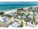 Stunning aerial view showcasing a vibrant coastal community next to a beautiful sandy beach at 104 Magnolia Ave, Anna Maria, FL 34216