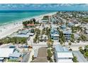 Breathtaking aerial view of coastal neighborhood and homes next to a beautiful, sandy beach at 104 Magnolia Ave, Anna Maria, FL 34216