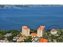 Stunning aerial view of two high-rise buildings with red tile roofs with the bay in the background at 1100 Imperial Dr # 507, Sarasota, FL 34236