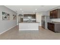 Open kitchen features dark cabinets, stainless steel appliances, and granite countertops at 12712 Dusty Trail Dr, Sarasota, FL 34238