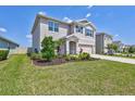 A two-story home features a manicured lawn and a two-car garage at 17330 Harvest Moon Way, Bradenton, FL 34211