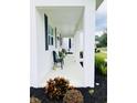 Stylish front porch with modern seating and decorative plants at 17605 Roanwood Ct, Parrish, FL 34219