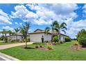 Charming single-story home with a two-car garage, lush landscaping, and a brick-paved driveway on a sunny day at 17725 Northwood Pl., Bradenton, FL 34202
