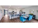 Open-concept kitchen and dining area with island seating and modern finishes at 18303 Wheathouse Pl, Lakewood Ranch, FL 34211