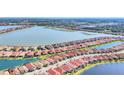 Aerial view of a community nestled by a lake and water canals with terra cotta roofs at 197 Villoresi Blvd, Nokomis, FL 34275