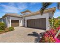 Beautiful home featuring a three-car garage and meticulously manicured landscaping at 204 Corelli Dr, Nokomis, FL 34275